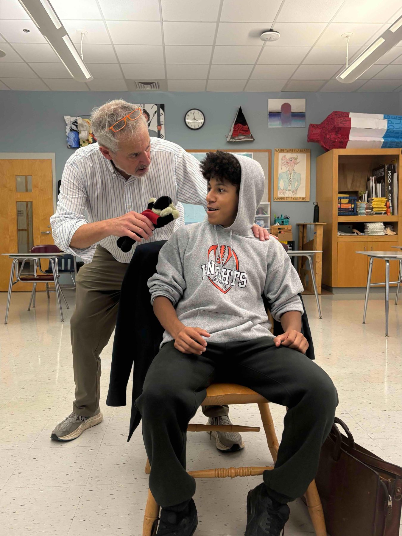 Jeff Levin working with a young man in a classroom