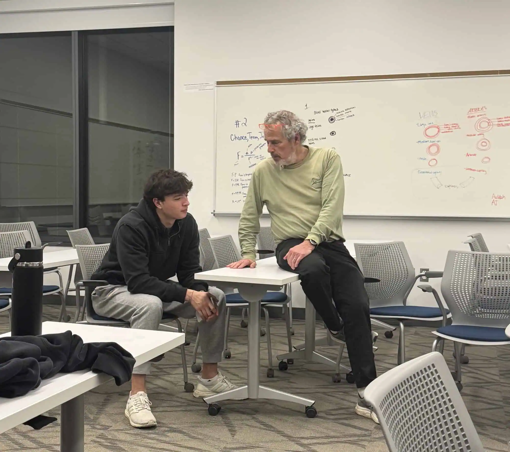 Jeff Levin with a young man in a classroom